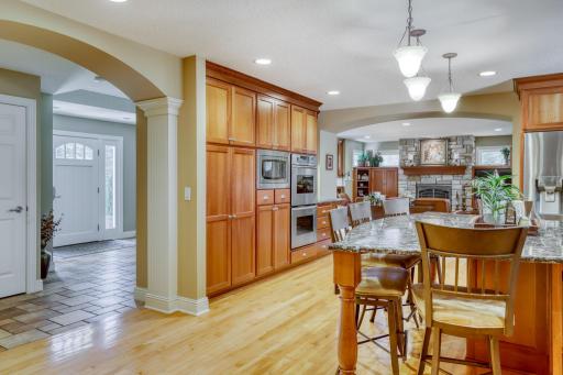 Everything centers on the kitchen. You can see the foyer on the left and the family room straight ahead. The dining and family room are behind you.