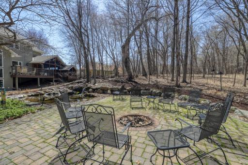 Backyard patio and firepit next to Koi pond.