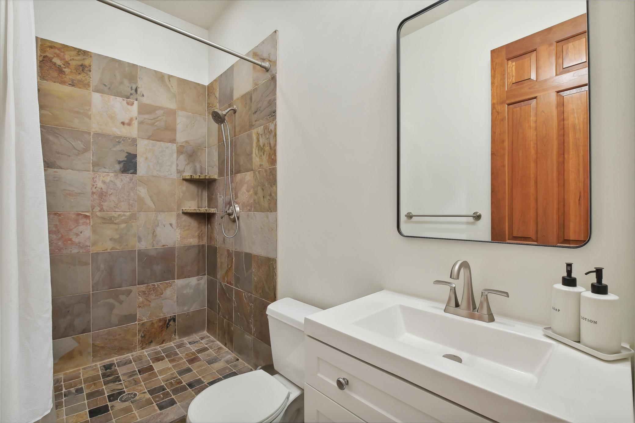 This three-quarter bathroom services the lower level.