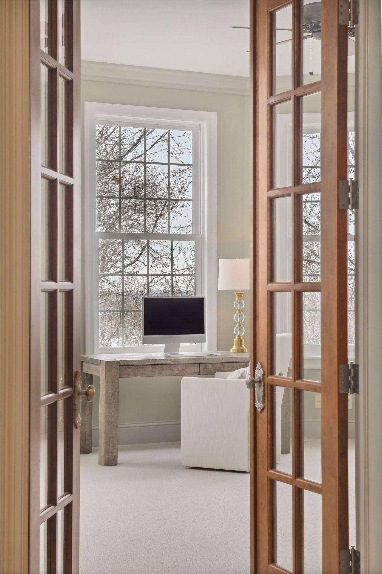 French doors open to reveal the private office.