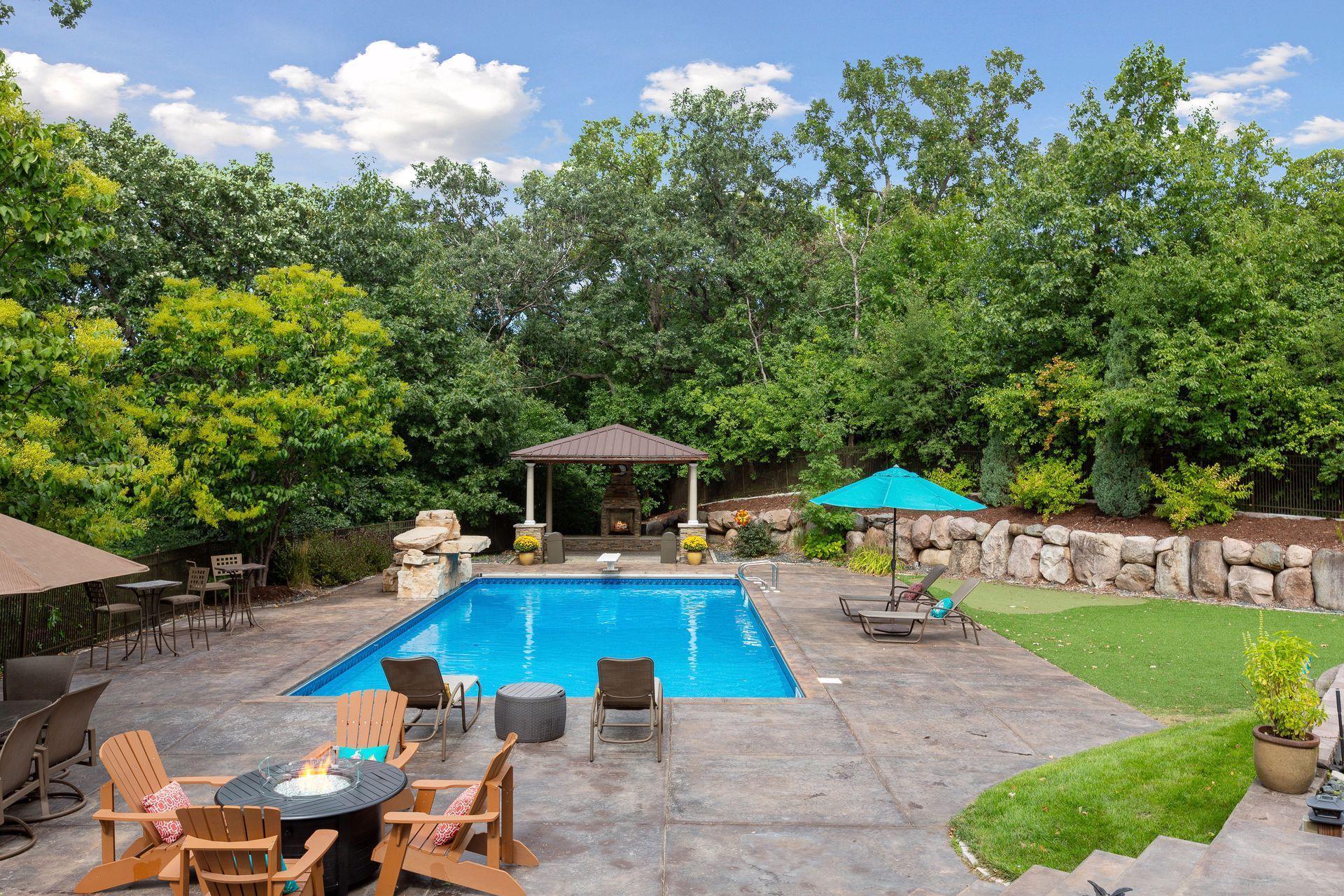 Perfectly manicured grounds include a pool with waterfall feature, pergola, stone fireplace, putting green and professional landscaping.