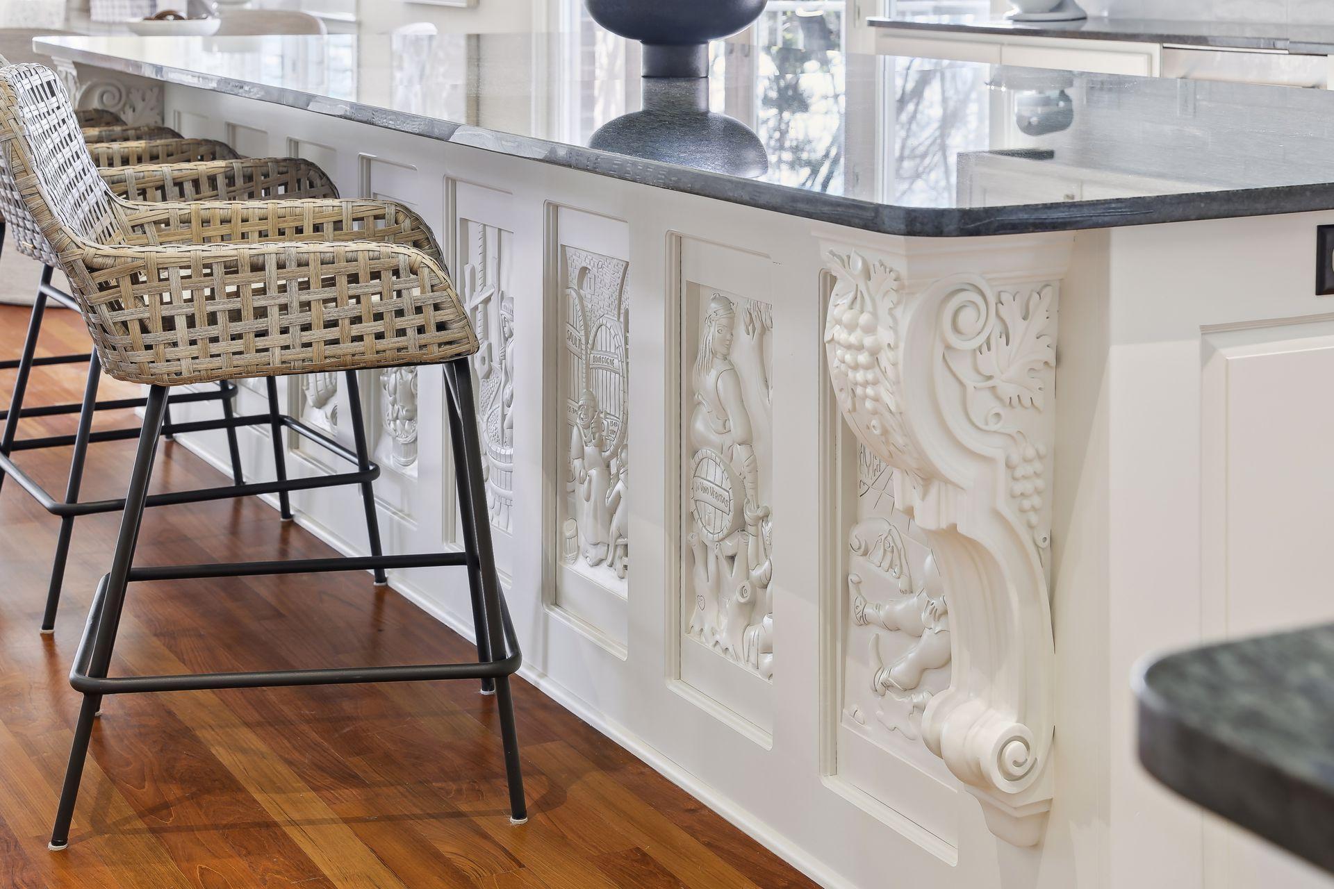 Custom woodwork on the center island depicts the story about how to make wine.