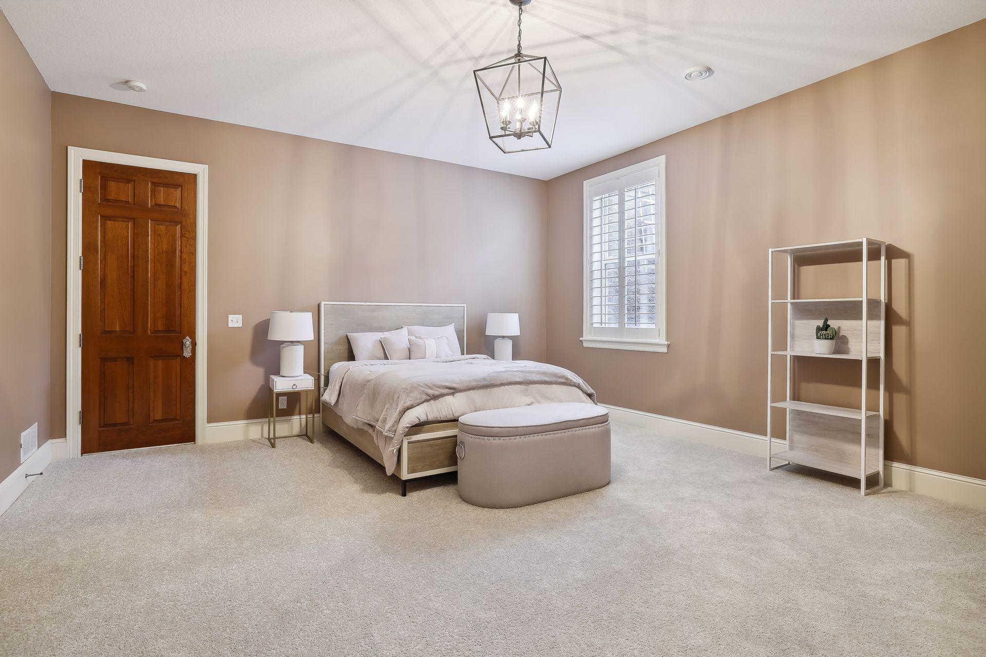 The fifth bedroom offers high ceilings and plenty of space for guests.