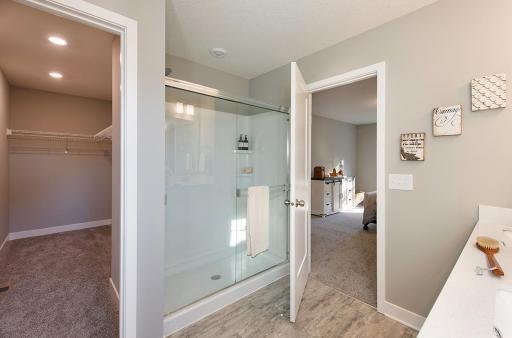 A view of the owner's shower and deep walk-in closet.
Photo from a similar home.