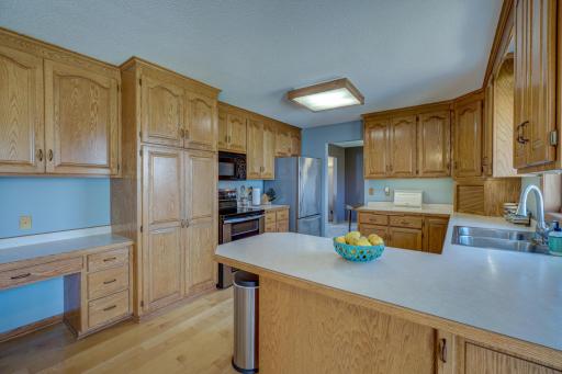 Kitchen offers lots of storage place and a peninsula for additional seating