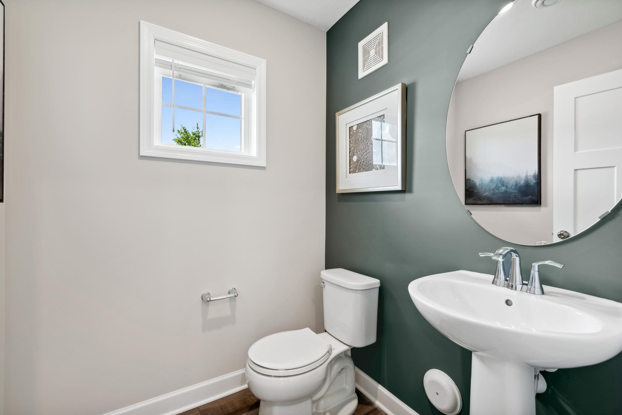 Main level powder bath. *Please note, photos are of a model and are not the actual home, but very similar.