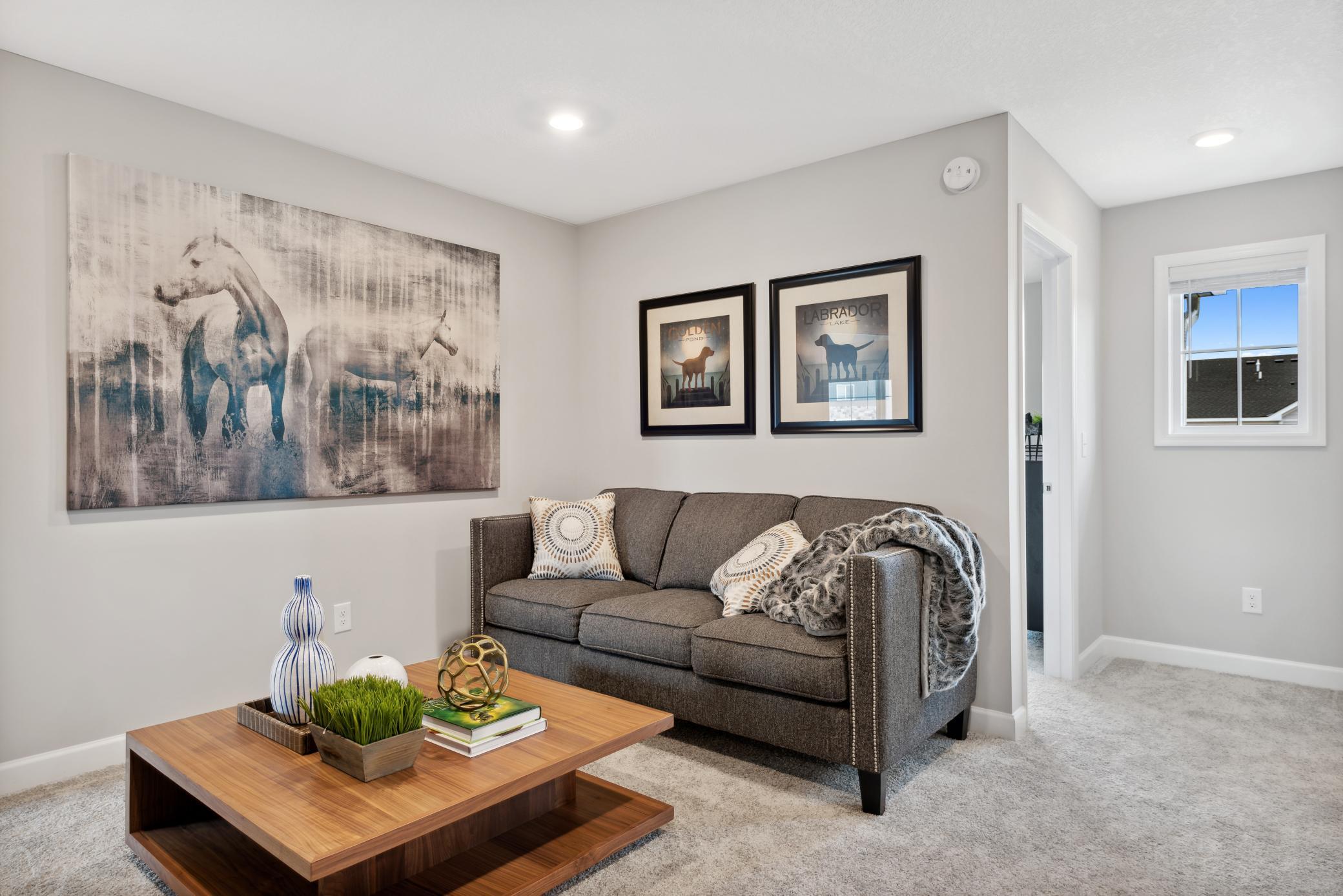 The upper level loft offers an additional seating area for watching TV, gaming, homework, etc. *Note, photos are of a model, not of actual home.