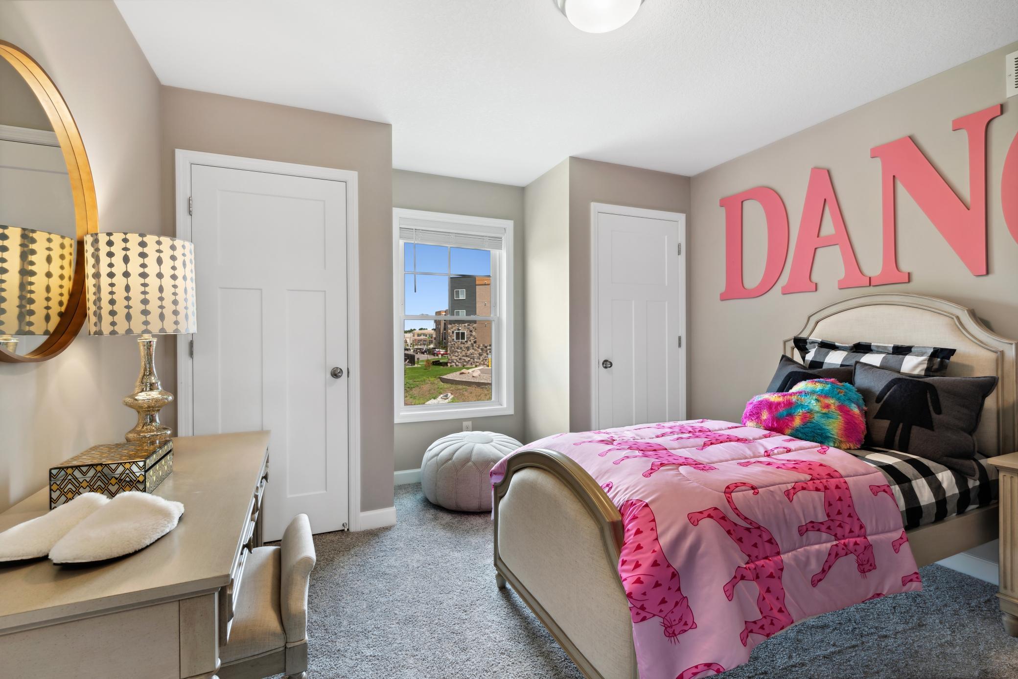 One of the secondary bedrooms features double closets and a great little nook, perfect for seating! *Please note, photos are of a model and are not the actual home, but very similar.