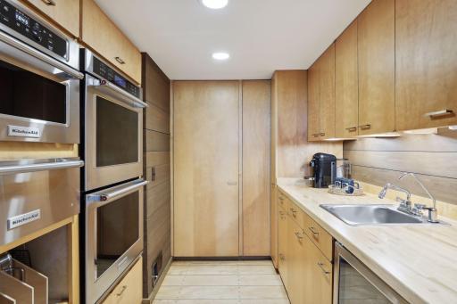 Butler Pantry with double oven, warming drawer, microwave oven, beverage fridge, exhaust fan and sink
