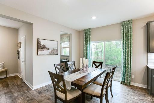 The informal dining/kitchen table space is out of the way yet a part of the space. Situated near the sliding patio door, this is a sunny, happy place to be not to mention the stunning view of mature trees/conservation area.
