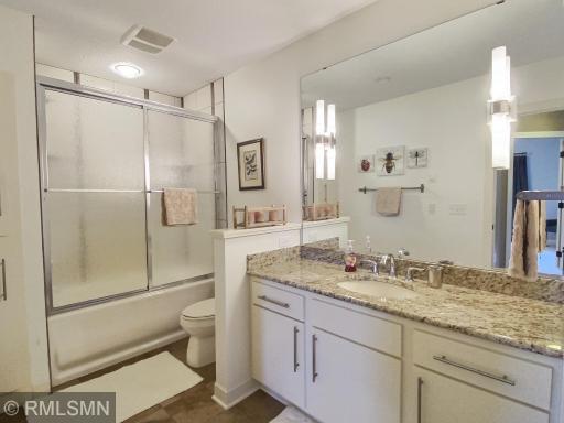 This full bathroom is located in the lower level and has beautiful granite counter tops.