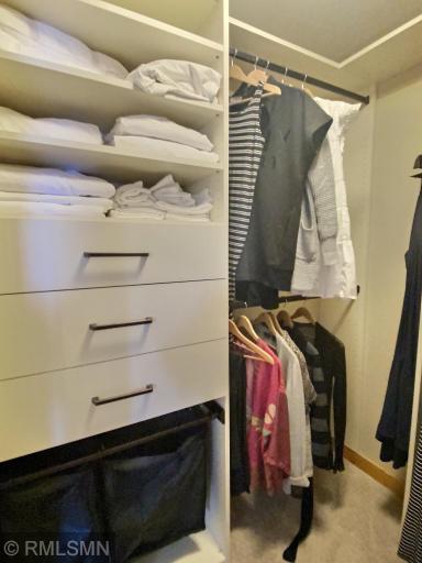2 walk-in closets in in the main floor bedroom. Both with built in drawers, shelving and hanging laundry baskets.