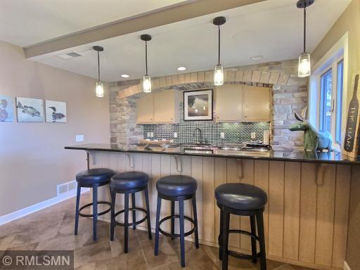 Entertaining will be easy with this well-appointed wet bar. Everything you need to be the perfect host. The cabinets are stocked with classic beverage glassware.