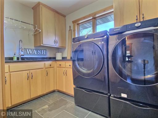 The laundry room is located on the main floor and has lots of storage, sink and granite counter tops. A pocket door can be shut to keep the noise down when doing laundry.