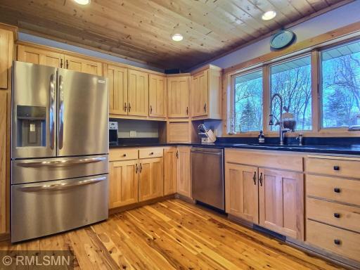 The well-appointed kitchen is stocked full of cookware, glassware, dishes, utensil, anything you need to prepare a meal and feed your friends and family. The cabinets are Maple and include a countertop bread box and 2 Lazy Susans in the corner units