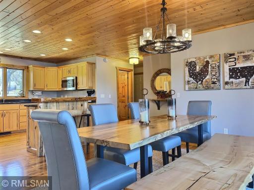 This table is amazing with more live edges, 4 comfortable gray leather chairs and a live edge bench.