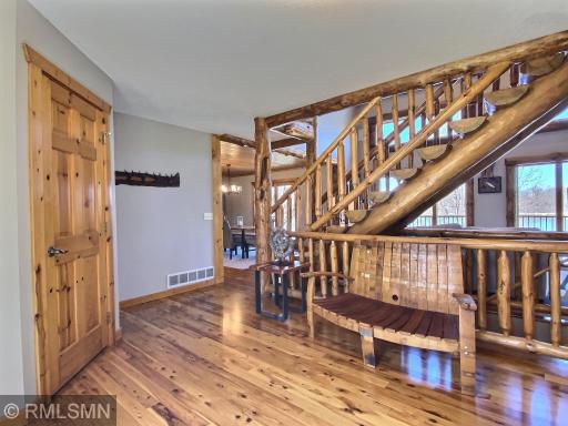 Welcome to the lake! Gleaming, recently refinished hard wood flooring will welcome visitors as they enter the front door, take a seat on the wine barrel bench. You can't help but be in awe of the massive log staircase,