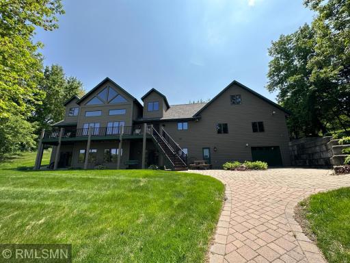 Beautiful paver brick patio and path leading to the lake and around the south side of the house to the garage.