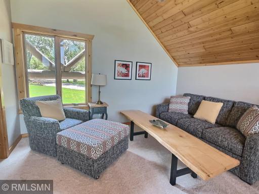 This lovely seating area on the loft over-looks the living room and the large lake side windows and is the perfect place to have some quiet time. The couch, chair and ottoman are beautifully upholstered and are a dream to sit on.