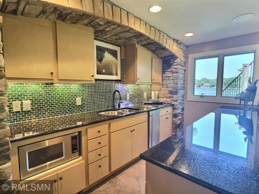 Full service wet bar. Including a microwave, ice maker, stove and beverage cooler. The beautiful tile back splash shimmers in shades of green and blue.