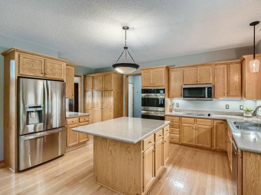 The open-concept kitchen has stainless steel appliances.