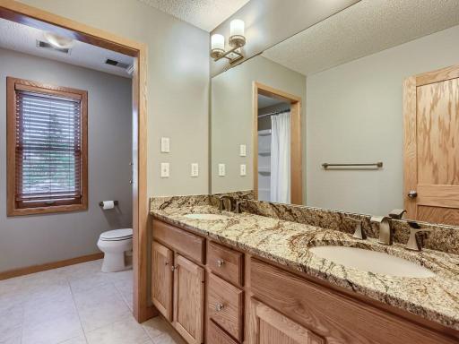 Another full bath with a water closet and granite-topped vanity.