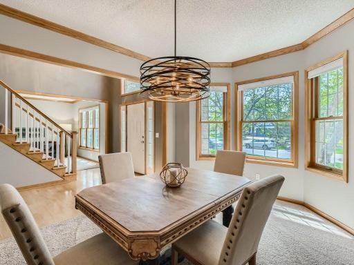 The formal dining room has modern updates (many light fixtures have been updated) and beautiful light.