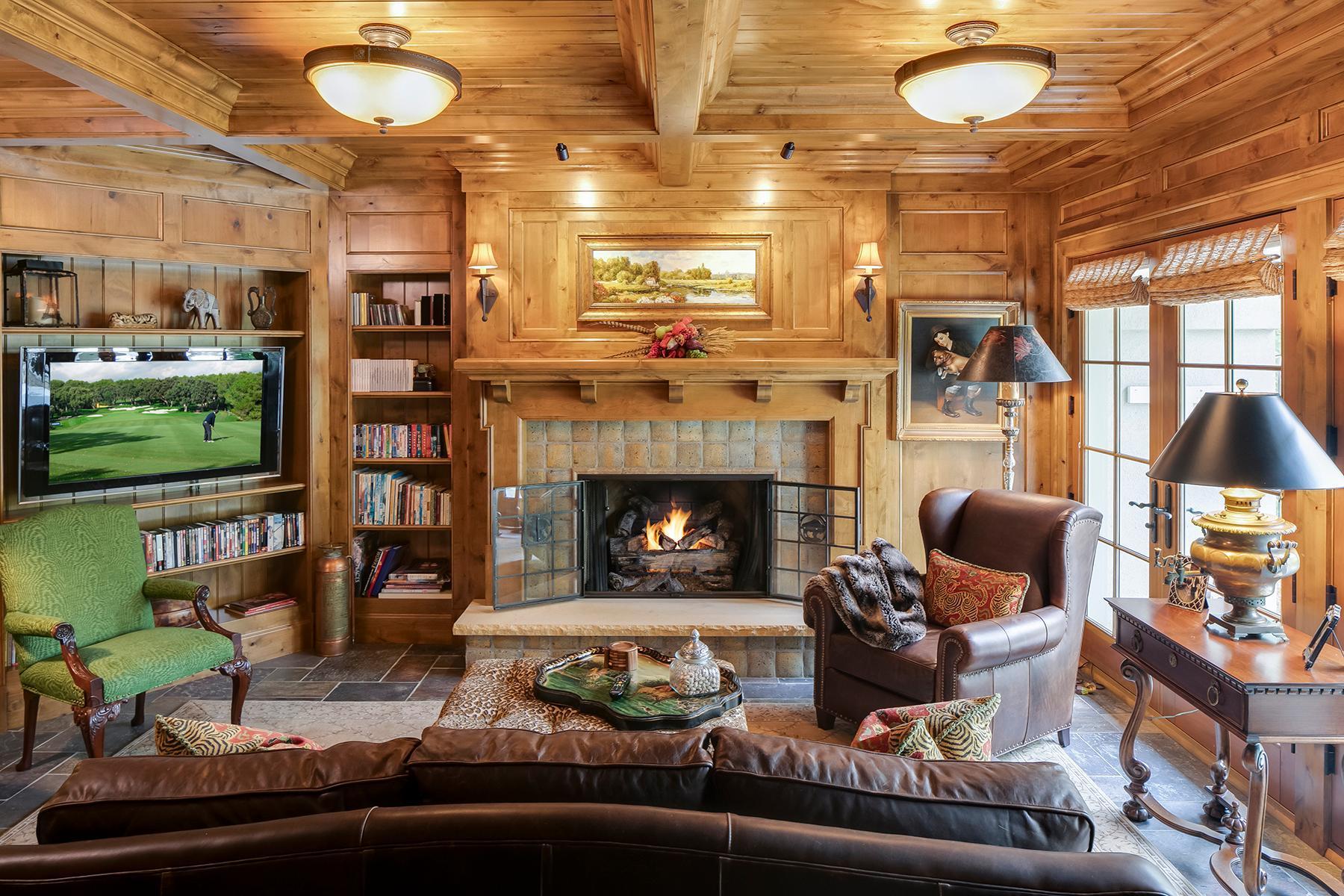 Cozy fireplace, paneled walls and built-ins
