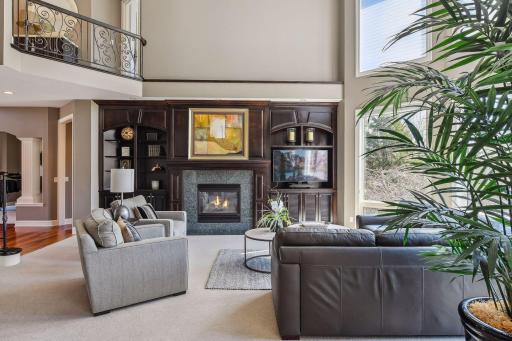 2 story ceiling, loads of windows and a stately fireplace