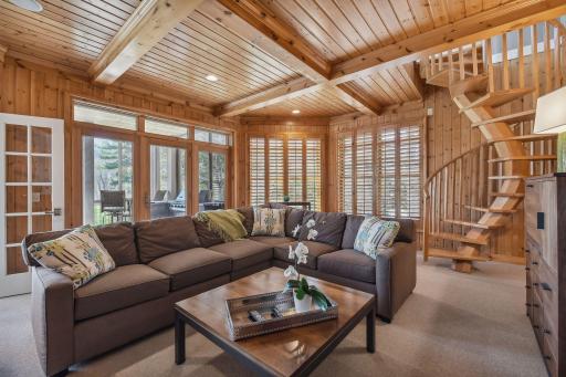 Many windows, adjacent screened porch and deck with spiral 2nd staircase to upstairs