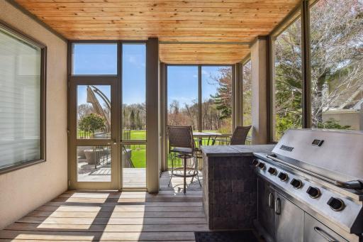 Back porch with large deck, stairs down to the sport court and large patio, fenced yard