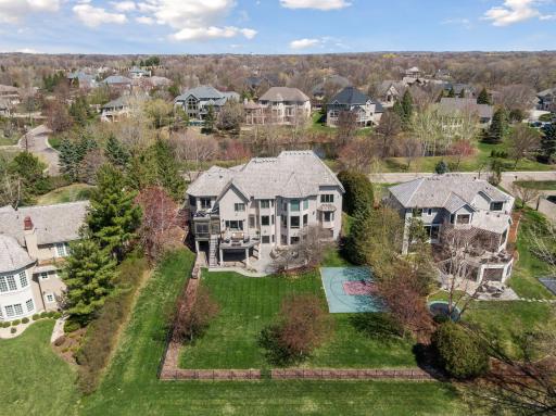 Note the fenced yard to the golf course with the sport court