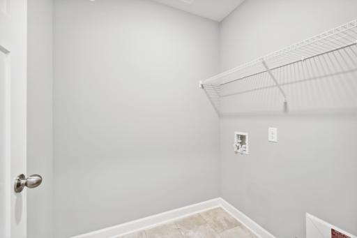 Laundry room conveniently located to the upstairs bedrooms. Photos are not of actual home. Actual home will be similar. Some colors and features may vary.