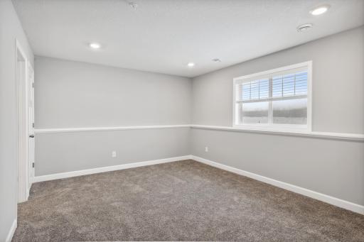 Finished lower level with a 4th bedroom which could be used for guests or an office. Photos not of actual home. Actual home will be similar floorplan; some colors and features may vary.