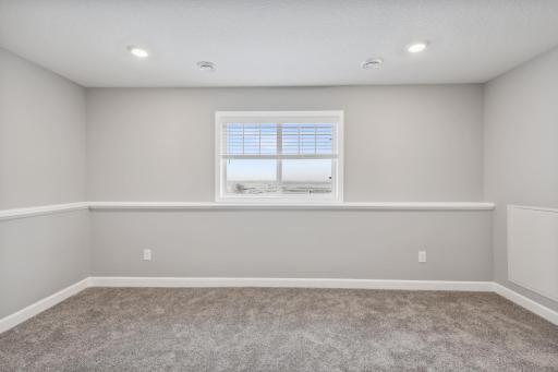 Finished lower level bedroom and bath. Photos not of actual home. Actual home will be similar floorplan; some colors and features may vary.