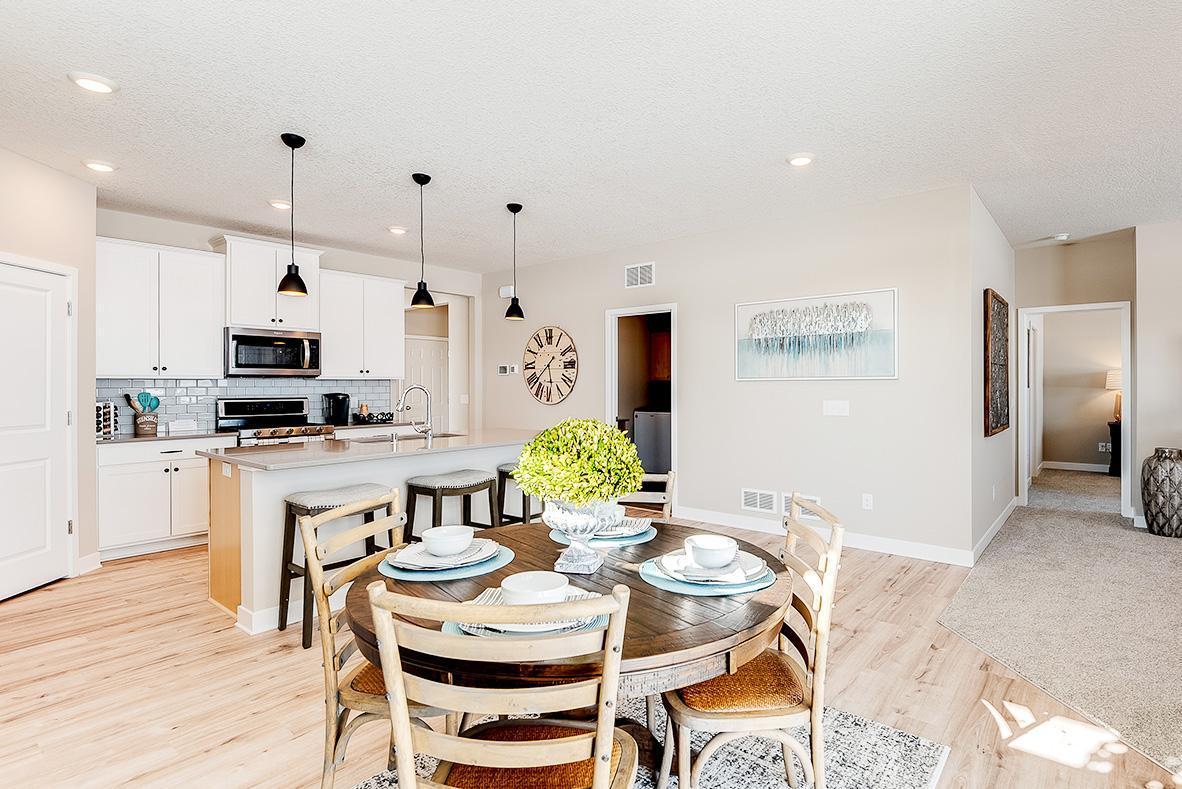 Informal dinette next to your sliding patio/deck door allows for an inflow of sunlight! Staged model photos. See listing agent for home specific selections.