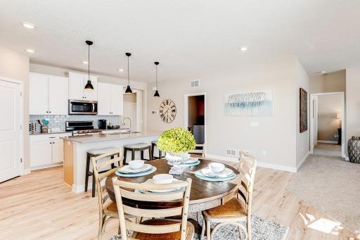 Informal dinette next to your sliding patio/deck door allows for an inflow of sunlight! Staged model photos. See listing agent for home specific selections.