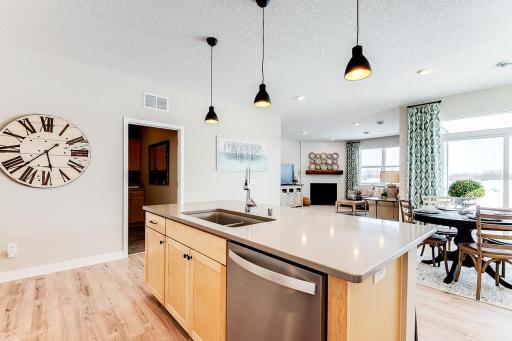 Fantastic sight from your kitchen island to the living room for watching TV or hosting friends and family. Staged model photos. See listing agent for home specific selections.