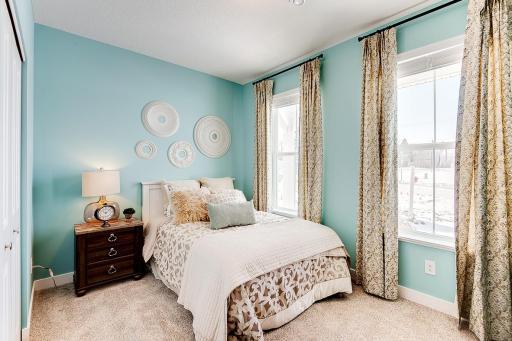 Front bedroom of the home is flooded with natural lighting! Great space for a home office or guest bedroom. Staged model photos. See listing agent for home specific selections.