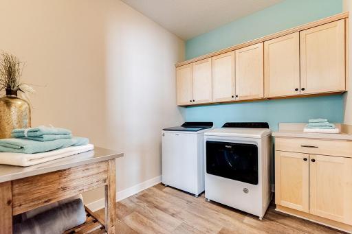 Large laundry room gives you space to wash, dry, fold, iron and for extra storage needs! Staged model photos. See listing agent for home specific selections.