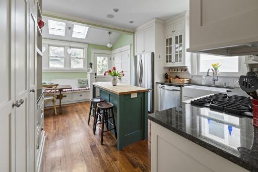 View to informal dining area with banquette seating and skylights.