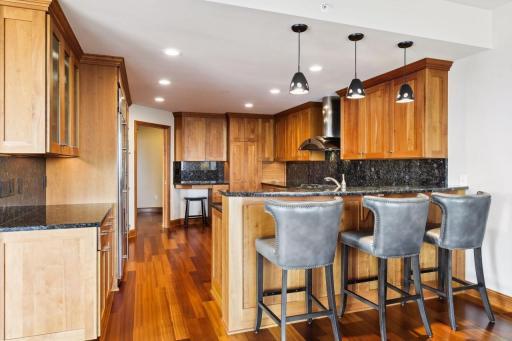 Kitchen features counter with space for three stools