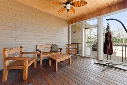 The inviting screen porch can be accessed from the kitchen and walks thru to the deck.