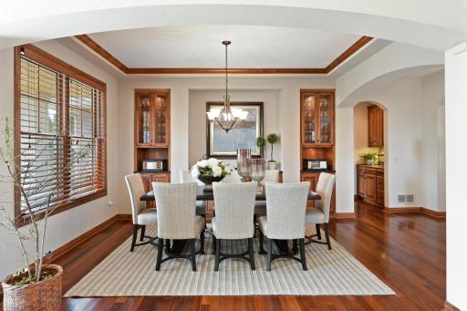 Both functional and beautiful the dining room features crown molding and built-in cabinetry with accent lighting.