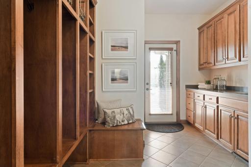 Fantastic Mud Room offers built-in cubbies, cabinetry and additional front entrance