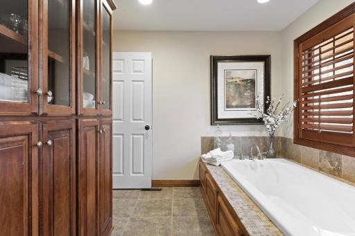 The Owners' bath features dual vanities, separate shower and jetted tub, built-in linen cabinet, separate water closet and large walk-in closet with custom organizers