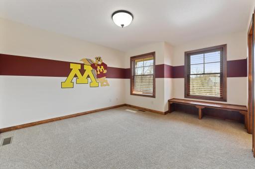 One of two bedrooms with built-in bench and walk-in closet that shares a full walk-thru bath