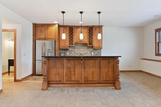 You'll love hosting gatherings with this great wet bar with island and bar seating