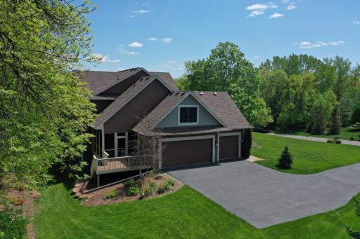 The end-load garage adds to the homes curb-appeal and walls of windows on the back fill the home with nature views and natural light.