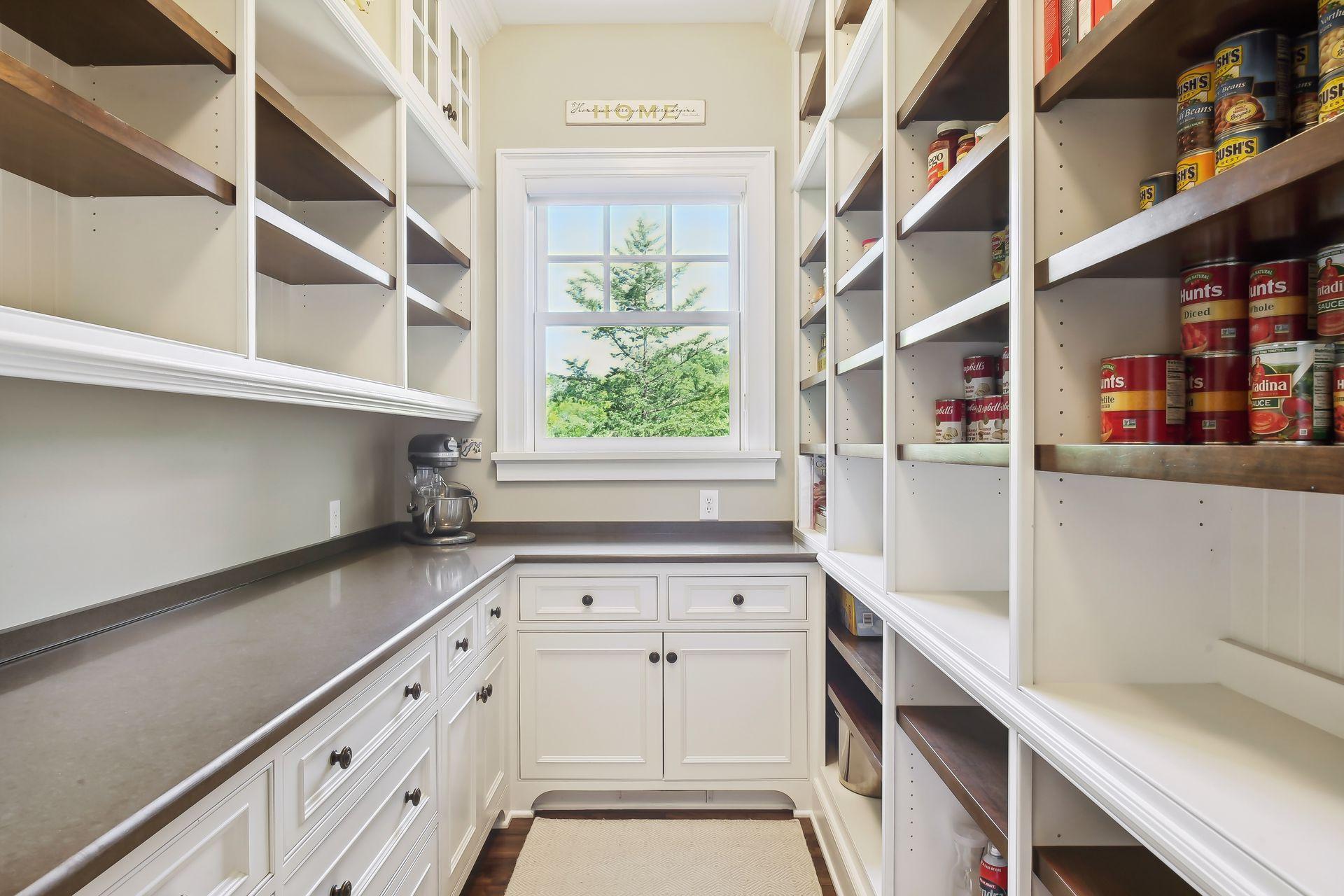 The pantry also includes extensive shelving, prep surface and cabinetry.